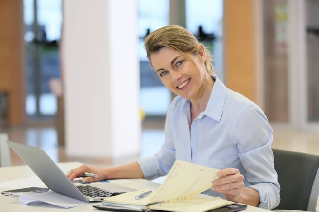 Businesswoman working in office on laptop