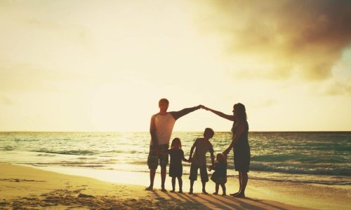 happy family with kids play at sunset tropical beach